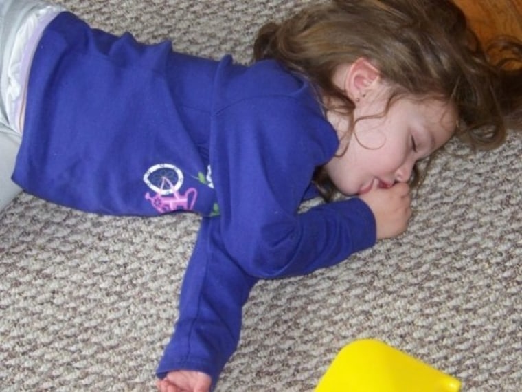 Little girl passed out on carpet