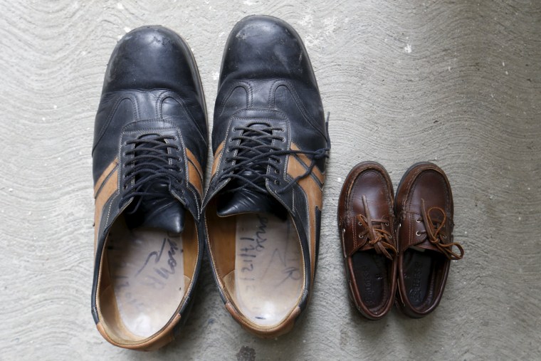 Image: The shoes of Jeison Rodriguez (L), the living person with the largest feet in the world, are seen next to the shoes of his nephew at his house in Maracay, Venezuela