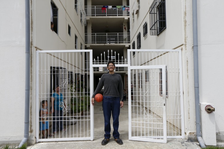 Image: Jeison Rodriguez (C), 19, the living person with the largest feet in the world, poses for a picture at his house in Maracay, Venezuela