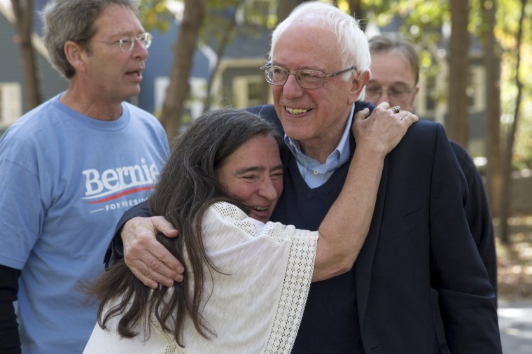Image: U.S. Democratic presidential candidate Bernie Sanders is hugged by supporter Gerhild Krapf before talking to supporters at a fundraising house party at the home of Krapf and Michael Brau in Iowa City