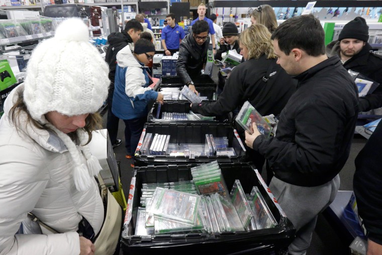 Image: Shoppers sift through video games at a Best Buy