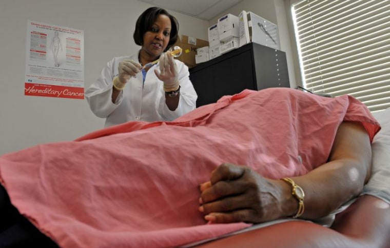 LANHAM, MD- MARCH 15 Dr. Regina Hampton prepares to insert a balloon catheter into a patient's breast for radiation treatment in Lanham, Maryland on March 15, 2012. Dr. Regina Hampton is a breast surgeon and medical director of Signature Breast Care in Lanham, Maryland. Photos for the Black Women series about breast cancer awareness. (Photo by Marvin Joseph/The Washington Post via Getty Images)