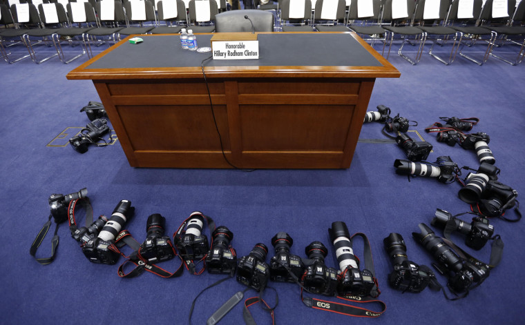 Image: Cameras from news photographers surround a table before the arrival of U.S. Secretary of State Clinton on Capitol Hill in Washington