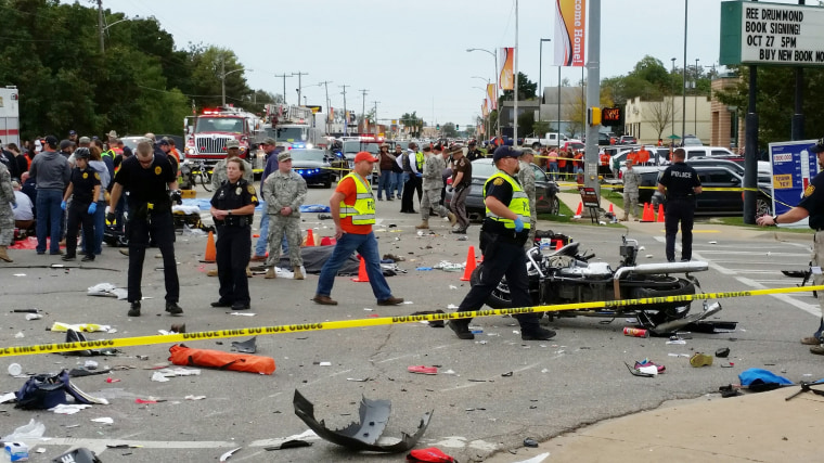 Image: Emergency personnel respond after a vehicle crashed into a crowd of spectators