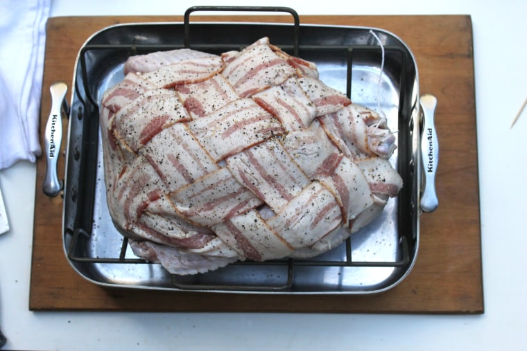 How to make bacon-wrapped turkey: place the turkey onto a roasting rack set in a roasting pan