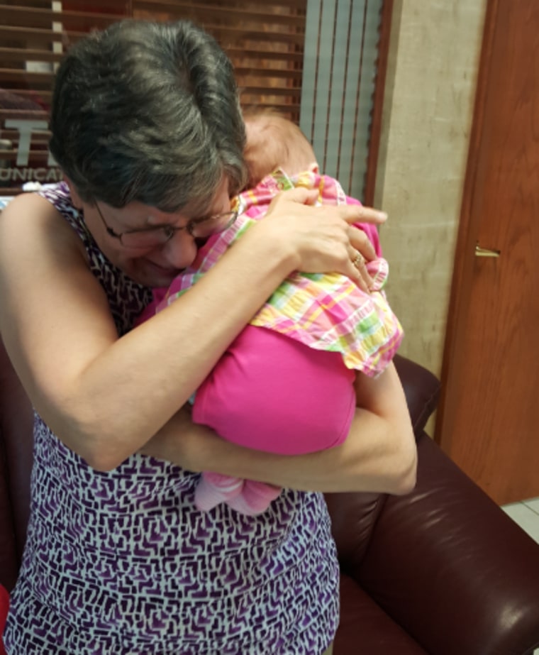 Sharon Bloomingdale hugs her granddaughter Ellie for the first time.