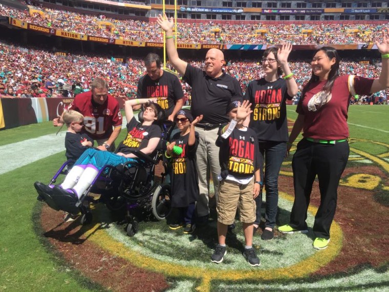 Hogan and daughter, Jaymi, joined pediatric cancer patients and their families on the field at a Washington Redskins game in September. It was at this game that Andrew Oberle (center) presented the governor with a list of tips for battling cancer.