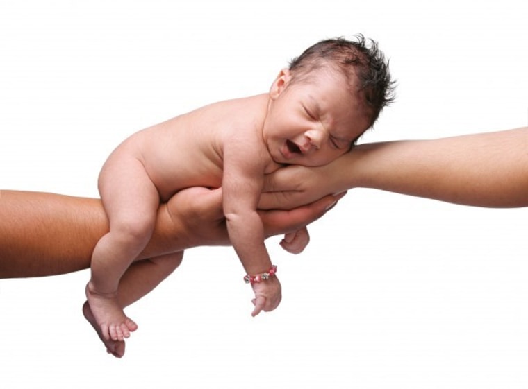 Baby sleeping in grown-up hands