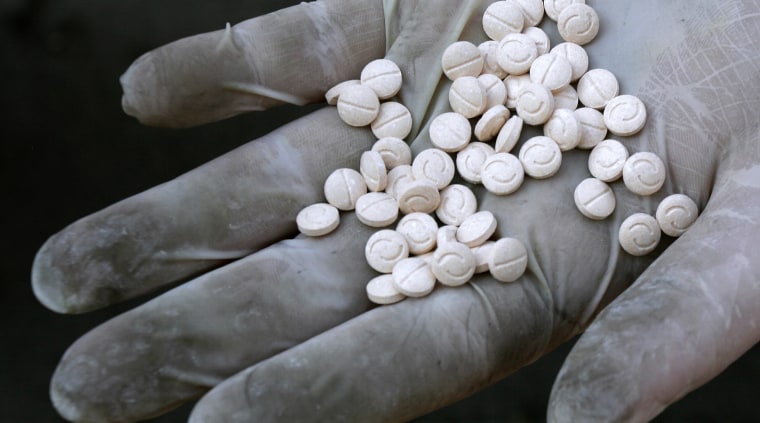 A customs officer displays Captagon pills, part of the 789 kilogrammes of confiscated drugs, before its incineration in Sofia