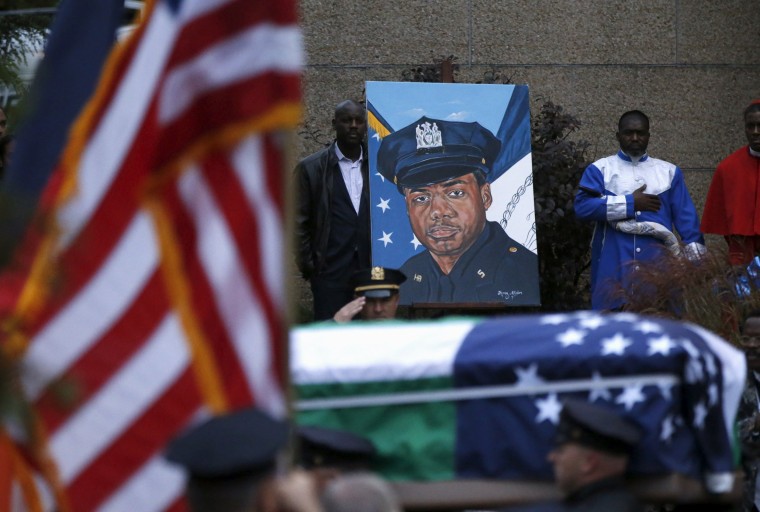 Image: Casket of slain New York City Police (NYPD) officer Randolph Holder is carried out following his funeral service in New York