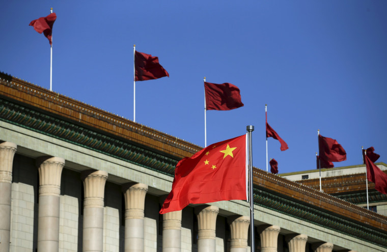 Image: Chinese flag waves in front of the Great Hall of the People in Beijing