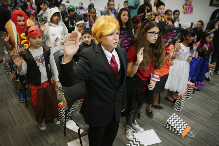 Image: A teenager dressed as Donald Trump takes the Oath of Allegiance