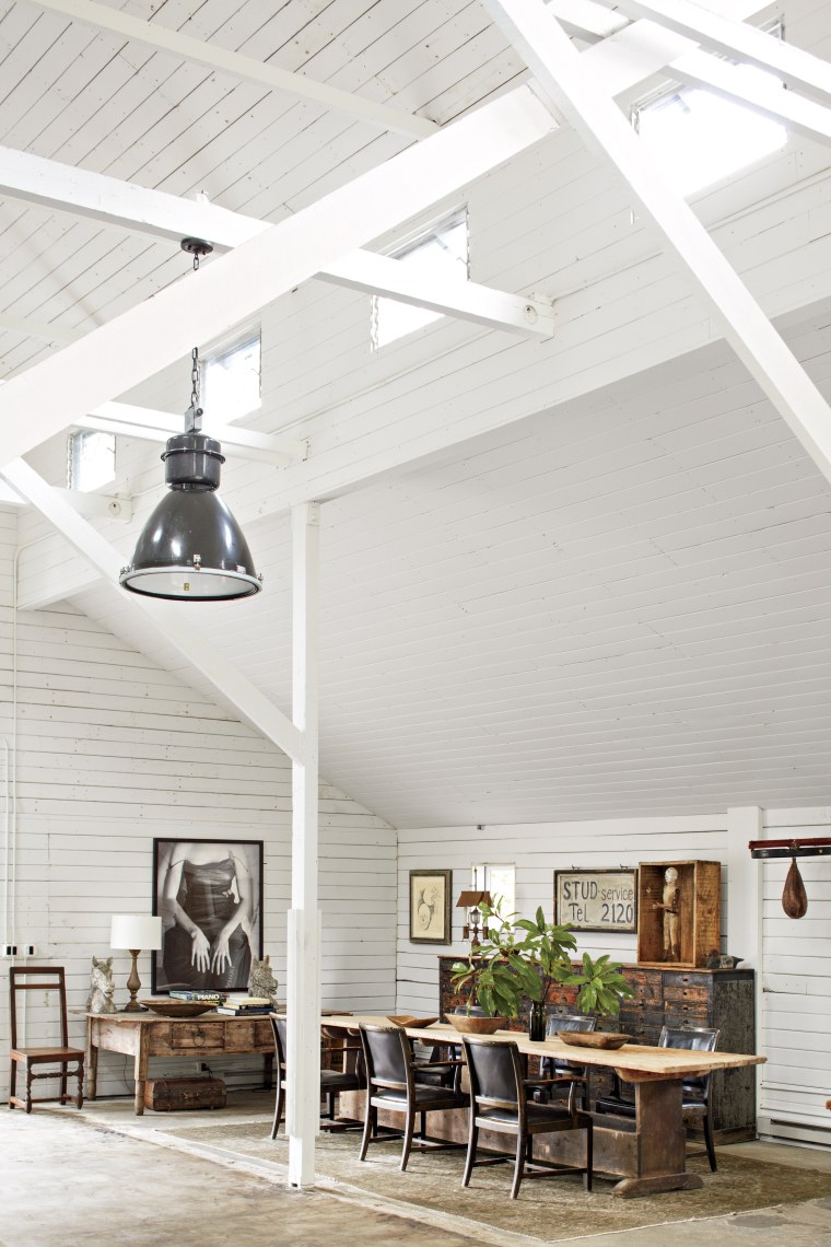 The dining room of the barn consisted of a seventeenth-century Swedish farm table surrounded by Swedish armchairs, circa 1930. The eighteenth-century Spanish desk, nineteenth-century cabinet, and antique American speed bag rounded out the room.