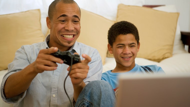 Image: Image: Image: Father and son playing video game