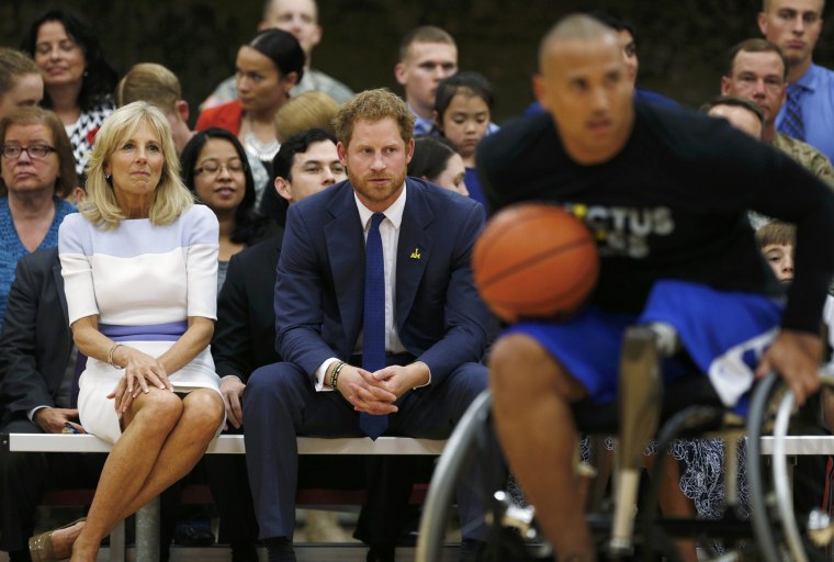 Image: Dr. Biden and Britain's Prince Harry watch a basketball game during a tour of the USO Warrior and Family Center at Fort Belvoir, Virginia