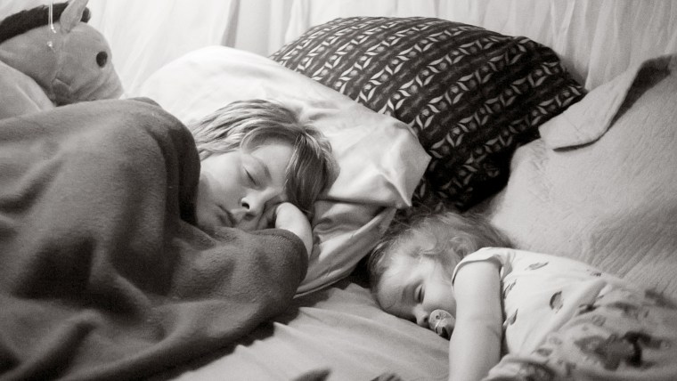 Zach, 11, and Elijah, 1, co-sleep in the bottom section of the Boyce's family bed.