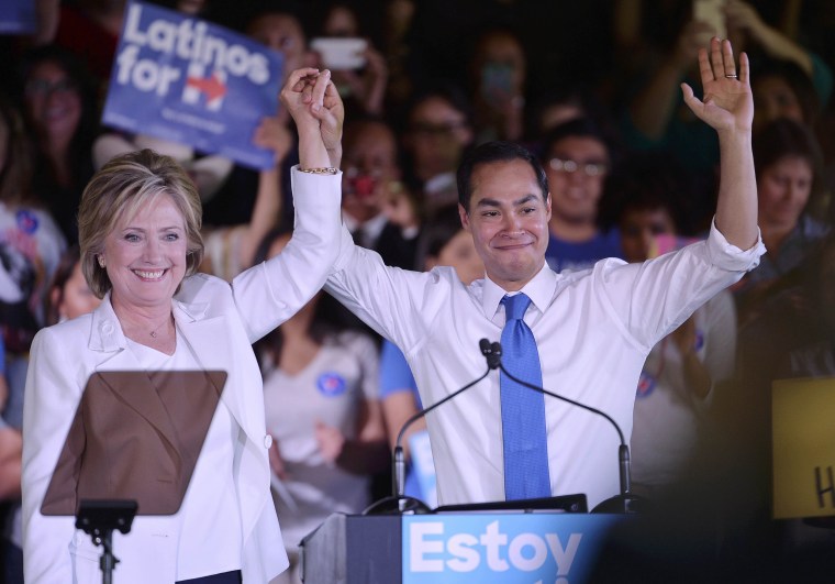 Image: Democratic U.S. presidential candidate Clinton holds the hand of HUD Secretary Castro after he endorsed her at a "Latinos for Hillary" rally in San Antonio, Texas