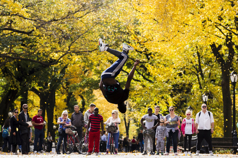 Image: A street performer jumps in the air