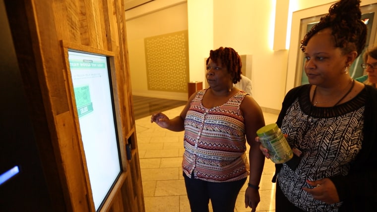 Two women in Chicago check out a Farmer's Fridge vending machine.