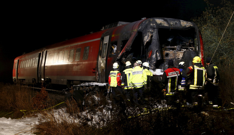 Image: Firefighters look for the train driver