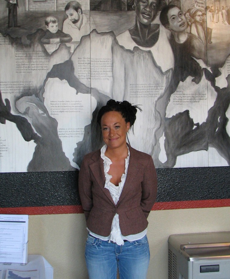 Image: Rachel Dolezal, a leader of the Human Rights Education Institute, stands in front of a mural she painted