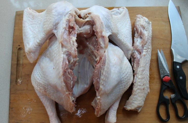 How to Butterfly a Turkey Step-by-Step: Using sturdy kitchen shears, cut out the backbone, following the lines created with the knife