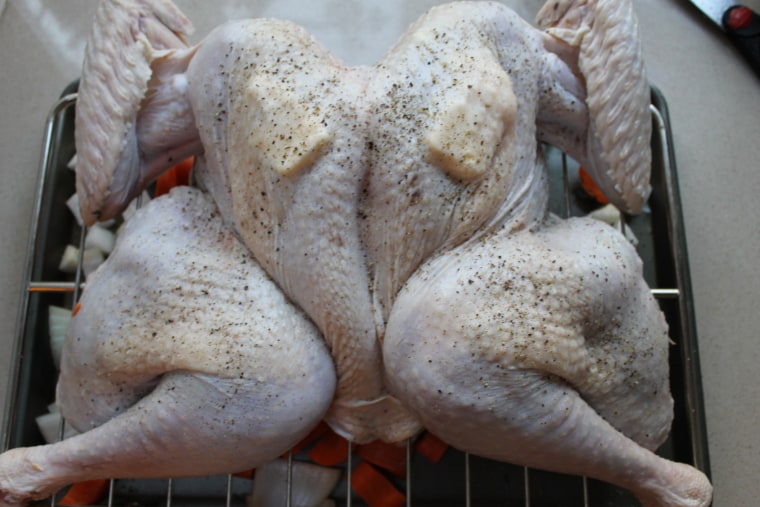 How to Butterfly a Turkey Step-by-Step: Slip the herb butter under the skin