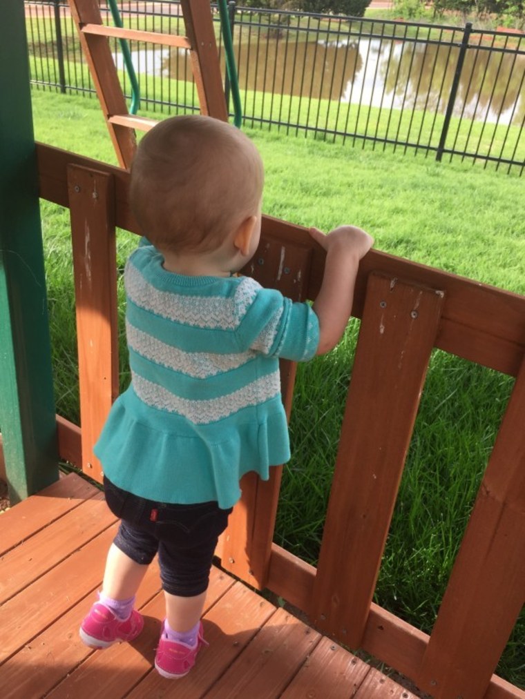 Baby girl standing on tiptoes
