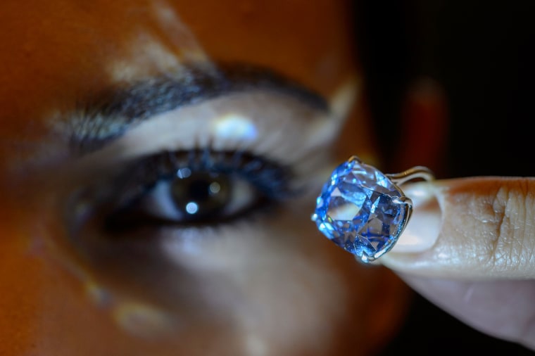 Image: A Sotheby's employee displays the rare Blue Moon Diamond