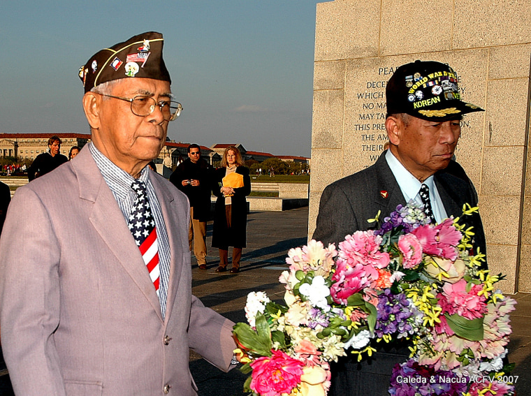 Artemio Caleda of Hawaii (left) and Regino Nacua of California march the wreath of flowers to the Bataan marker at the National World War II Memorial during the Day of Valor anniversary April 9, 2007. Caleda’s service has been recognized by the VA to receive citizenship and some medical benefits. But because he is listed by his military alias in the U.S. Army official records, he has been denied a $15,000 lump sum benefit granted to Filipino-American veterans of WWII.