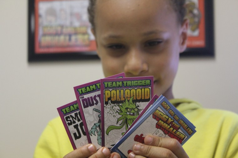 A young patient holds “Iggy and the Inhalers” trading cards.