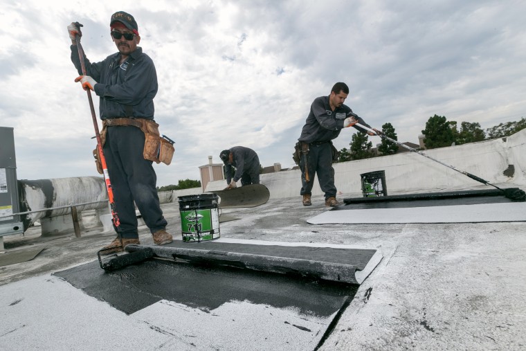 Image: Roofers Javier Rubio, left, and Joel Camberos