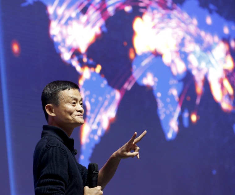 Image: Alibaba founder and chairman Jack Ma gestures in front of a screen