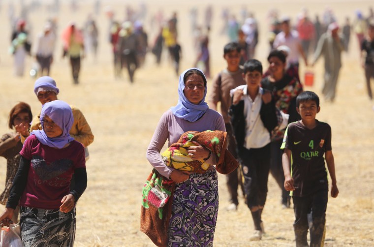 Image: Yazidis trapped in the Sinjar mountains are rescued