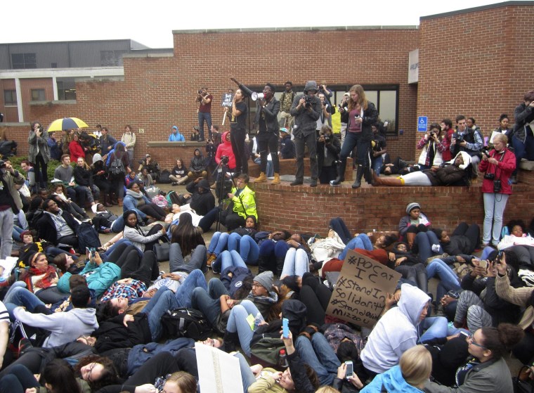 Image: Leaders from the group People of Color encourage students to lay down as part of a die-in this afternoon at Ithaca College in Ithaca, New York