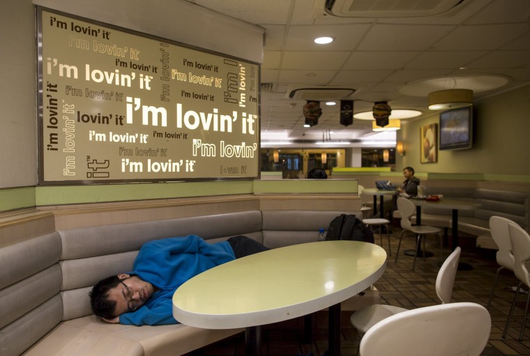 Image: A man sleeps at 24-hour McDonald's in Hong Kong
