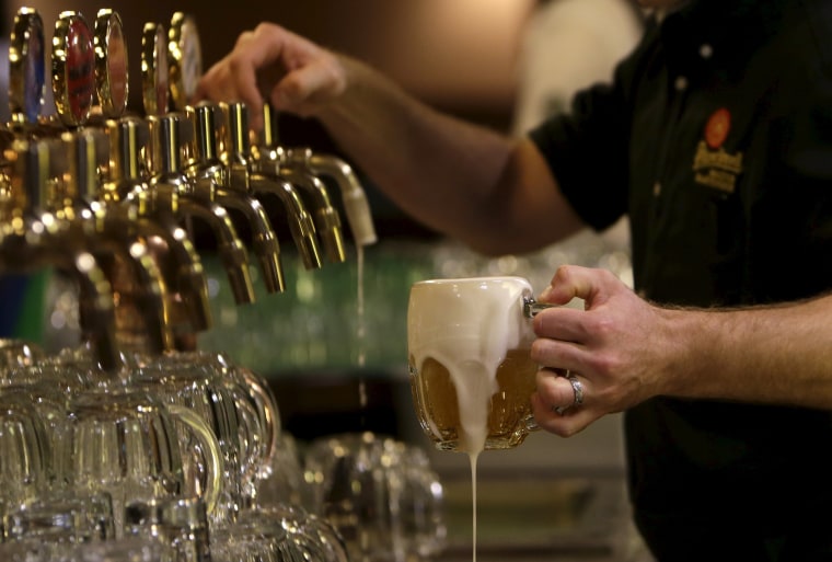 Image: A bartender drafts a glass of beer at Plzensky Prazdroj (Pilsner Urquell) brewery in Plzen