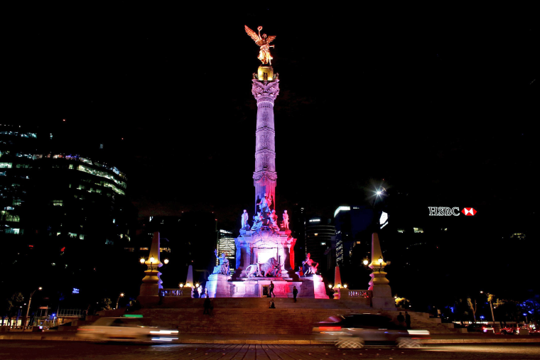 Image: Angel de la Independencia monument is lit up in blue, white and red, the colors of the French flag, following the Paris terror attacks, in Mexico City