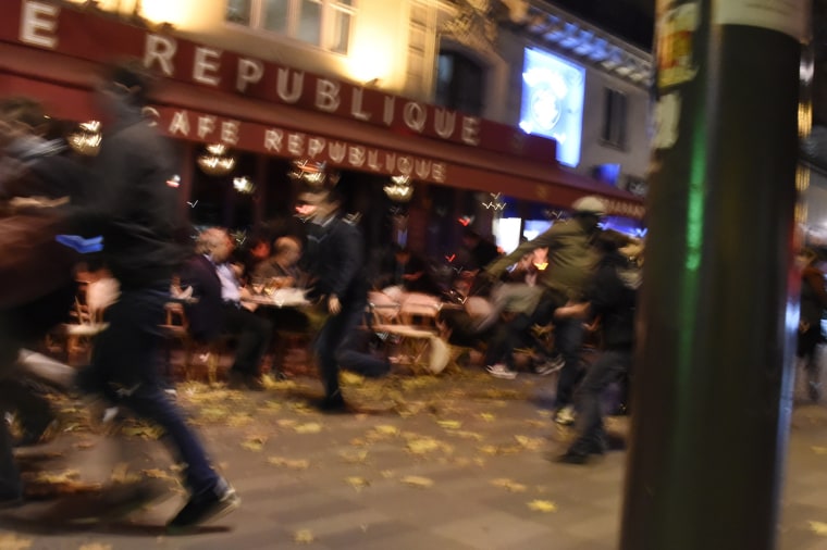Image: People flee after attack near Place de la Republique in Paris