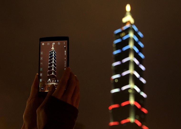 Image: Taiwan's landmark building Taipei 101 is lit up in blue, white and red, the colors of the French flag, following the Paris attacks, in Taipei