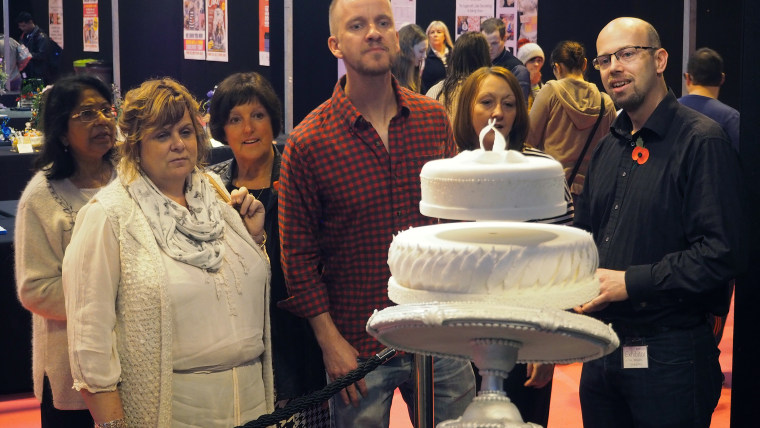 People confused by the cake at the Cake International Show.