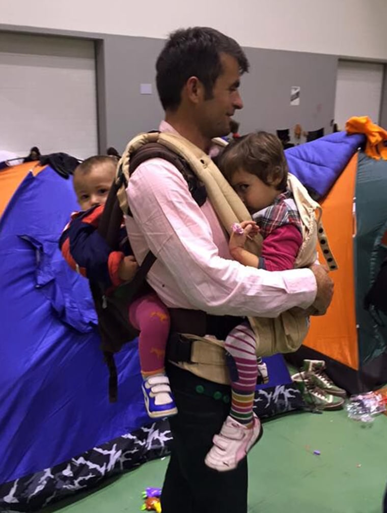 An Afghan father in a refugee camp outside of Athens asked Carry the Future reps to teach him how to wear both of his small children.