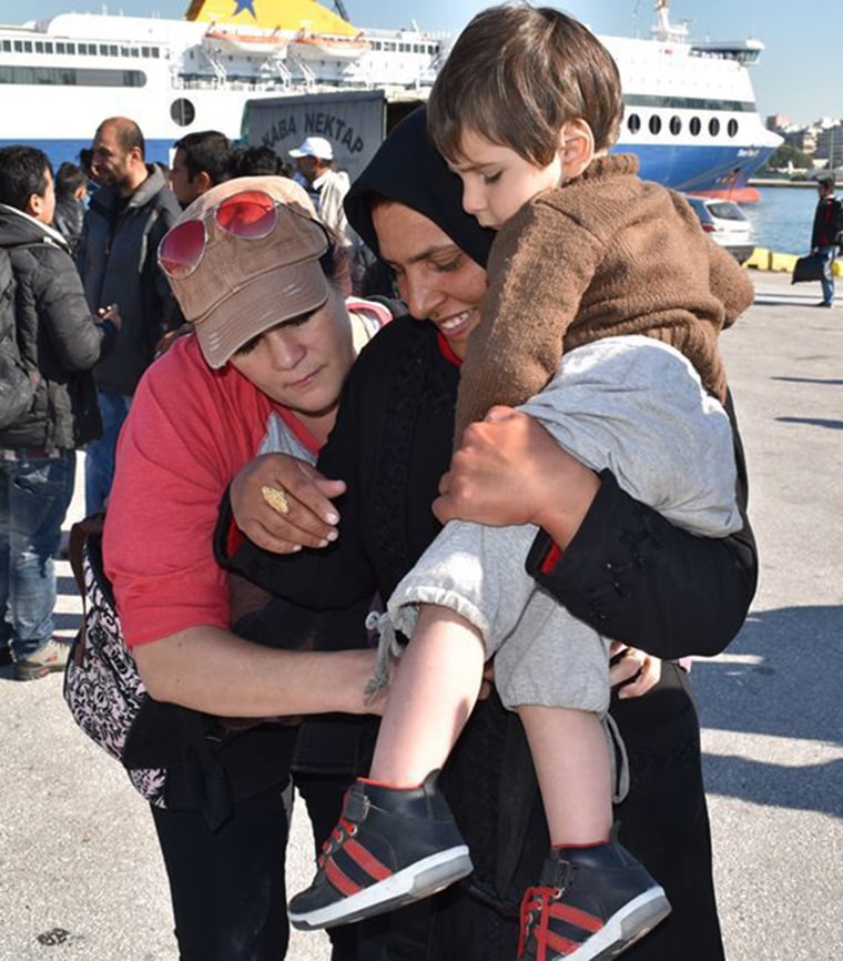 Amy Evans, a Carry the Future volunteer and mother of two from California, shows a mom how to wear her child in a donated carrier. She says, “I’m humbled to be here… I felt absolutely no language barrier and I feel like a tool to help these mothers get to their safe space."