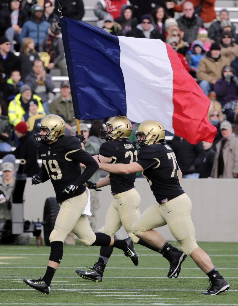 Army players carry the flag of France onto the field before an NCAA college football game against Tulane on Saturday, Nov. 14, 2015, in West Point, N.Y.