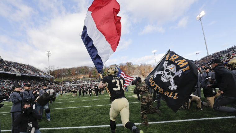 Army players carry the flag of France onto the field before an NCAA college football game against Tulane on Saturday, Nov. 14, 2015, in West Point, N.Y.