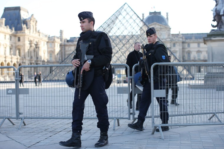 Image: Police walk around the closed Louvre museum