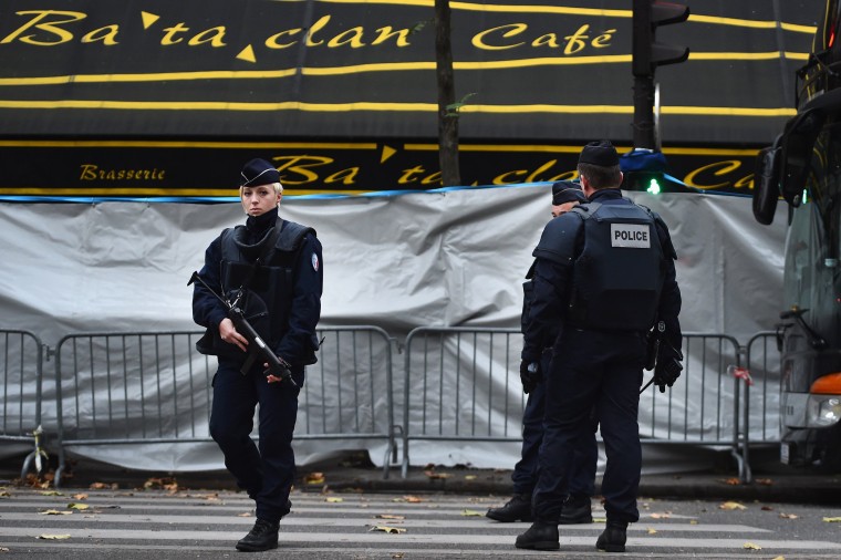 Image: French police officers stand guard in front of the main entrance of Bataclan