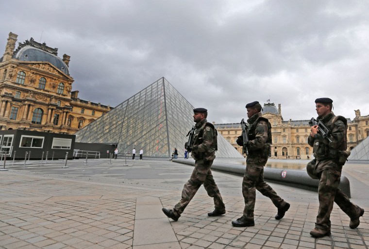 Image: Soldiers patrol in the courtyard of the Louvre Museum