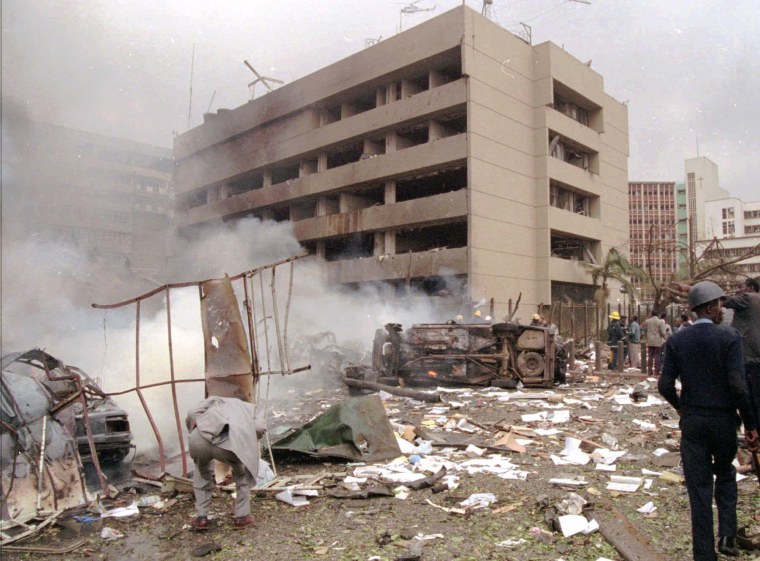 Image: Damaged cars and debris cover the ground outside the U.S. Embassy in Nairobi in 1998