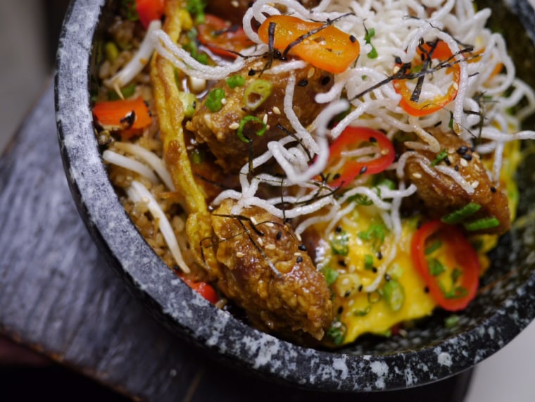 Chinese-Peruvian chef Jesus Delgado cooks up Chinese-influenced dishes, known in Peru as a “Chifa” style dish.